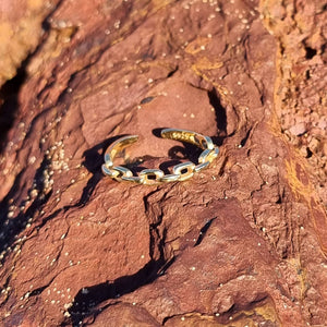 Our Chain Ring is a bold piece featuring a chain like front feature with an adjustable back closure. We recommend pairing the Chain Ring with two or more of our other Salaqua rings for the best look and feel.  Material:  18K Gold Vermeil with a Sterling Silver base