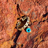 Our Evil Eye Pendant Chain Ring is elegant, playful and bold. For the woman unafraid of standing out in the crowd and making a statement. Featuring a beautiful curb chain adjustable band and an Evil Eye pendant. We recommend pairing the Chain Ring with two or more of our other Salaqua rings for the best look and feel.  Material:  18K Gold Vermeil with a Sterling Silver base